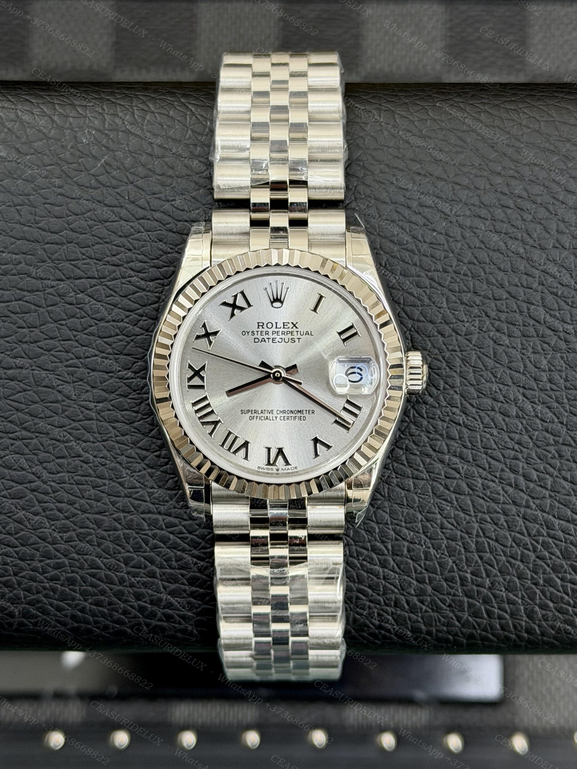Rolex Datejust 31 Steel — Silver Roman Dial (Fluted + Jubilee) Background
