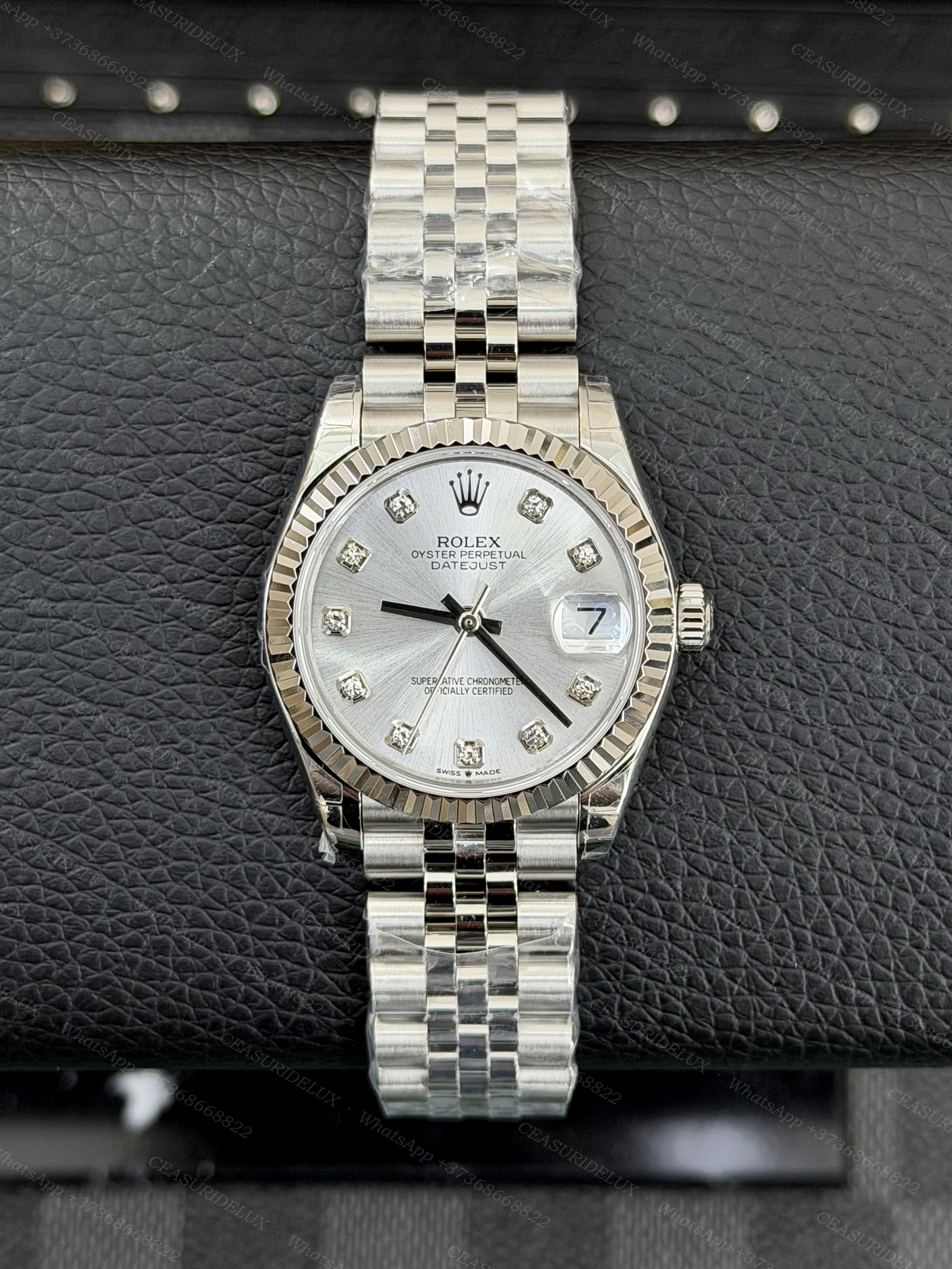 Rolex Datejust 31 Steel — Silver Diamond Dial (Fluted + Jubilee) Background